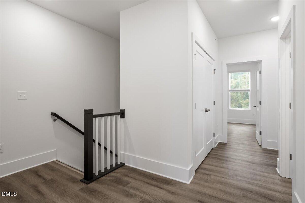 509 Kildaire Farm Road, Unit 302 Cary, NC 27511 - Photo 25 of 30 a view of a hallway with wooden floor and entryway