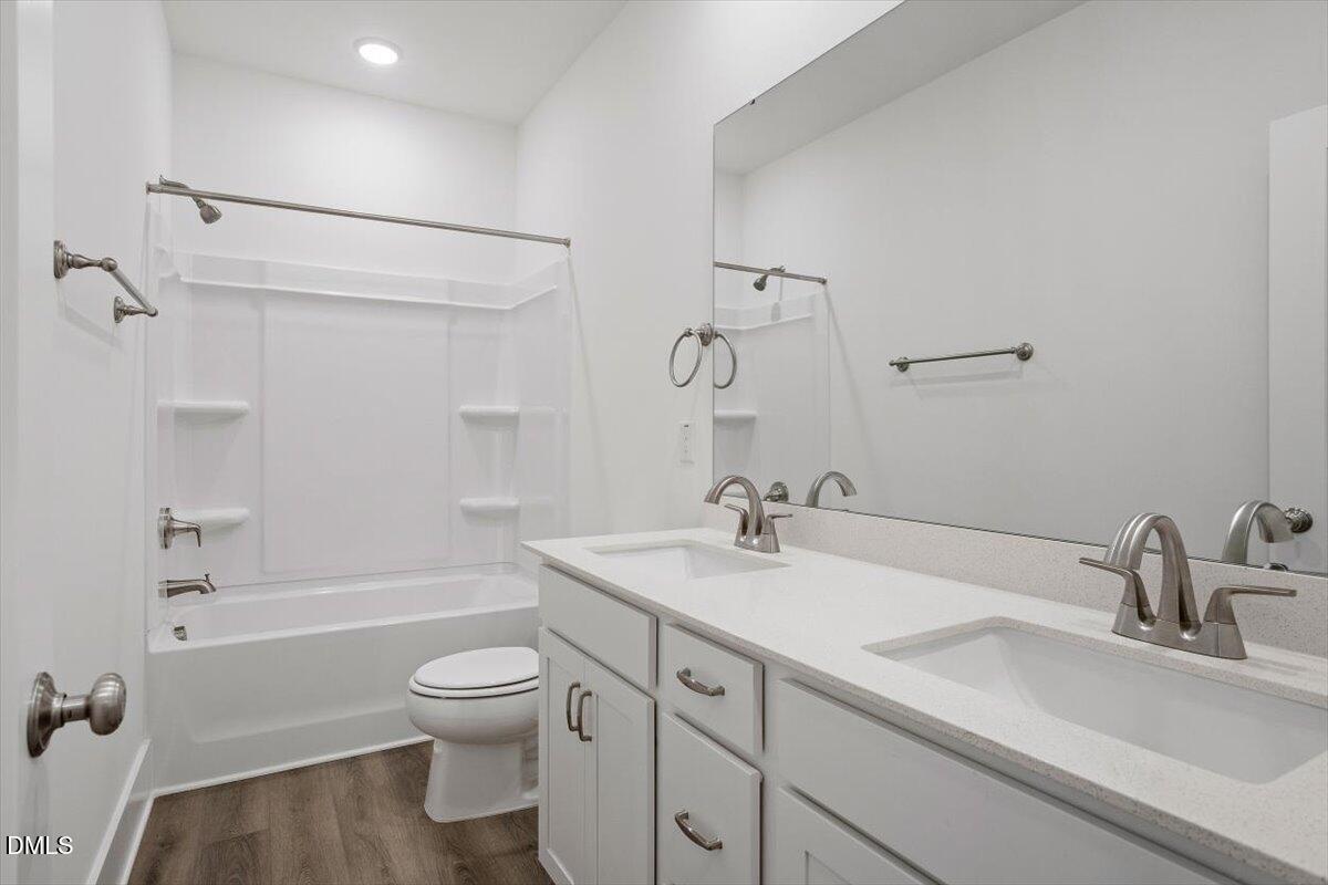 509 Kildaire Farm Road, Unit 302 Cary, NC 27511 - Photo 26 of 30 a bathroom with a sink toilet tub and shower
