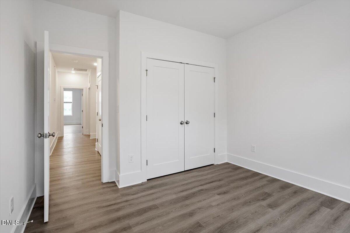 509 Kildaire Farm Road, Unit 302 Cary, NC 27511 - Photo 28 of 30 wooden floor & wooden door in an empty room