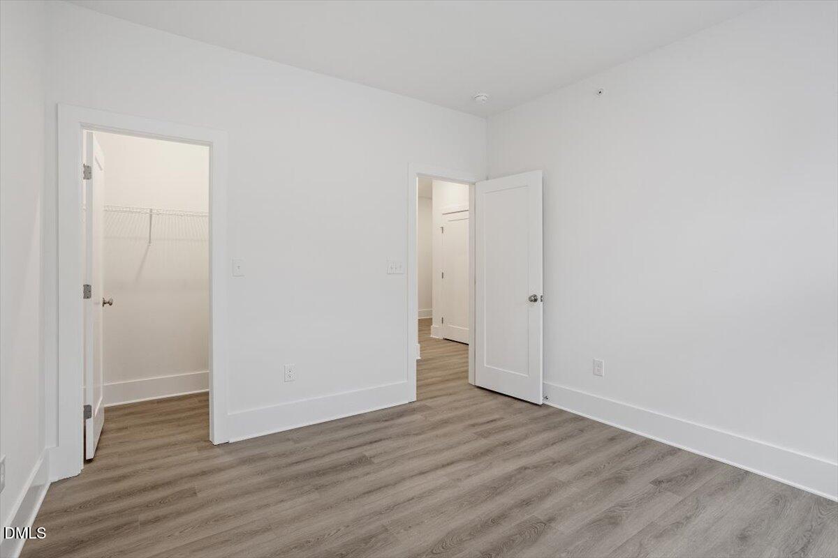 509 Kildaire Farm Road, Unit 302 Cary, NC 27511 - Photo 30 of 30 a view of a room with wooden floor