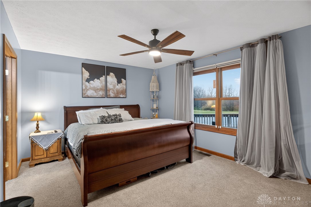 5264 Frazier-Guy Road Sidney, OH 45365 - Photo 21 of 51 This spacious bedroom offers a tranquil retreat with ample natural light and plush carpeting.