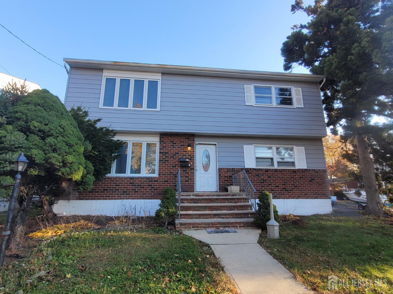 a front view of a house with a yard and outdoor seating
