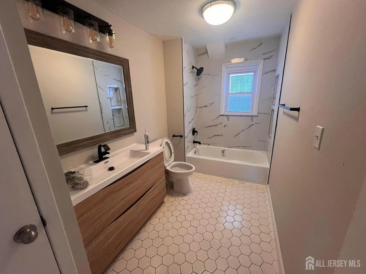 249 Olsen Street, Unit 2 Sayreville, NJ 08879 - Photo 14 of 24 a bathroom with a sink a toilet and shower