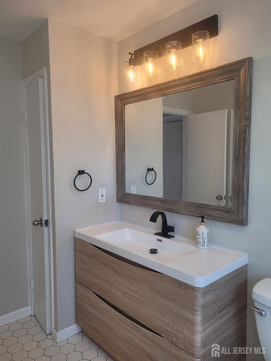 249 Olsen Street, Unit 2 Sayreville, NJ 08879 - Photo 15 of 24 a bathroom with a sink and a mirror