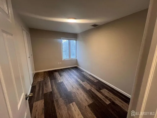 a view of wooden floor and windows in a room