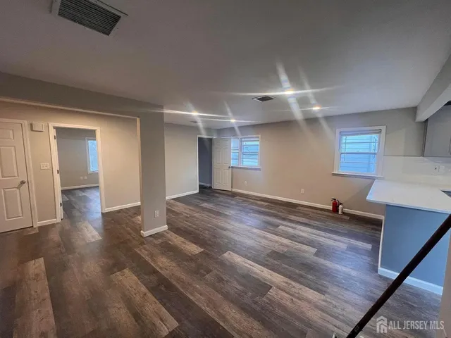 a room with wooden floor and window