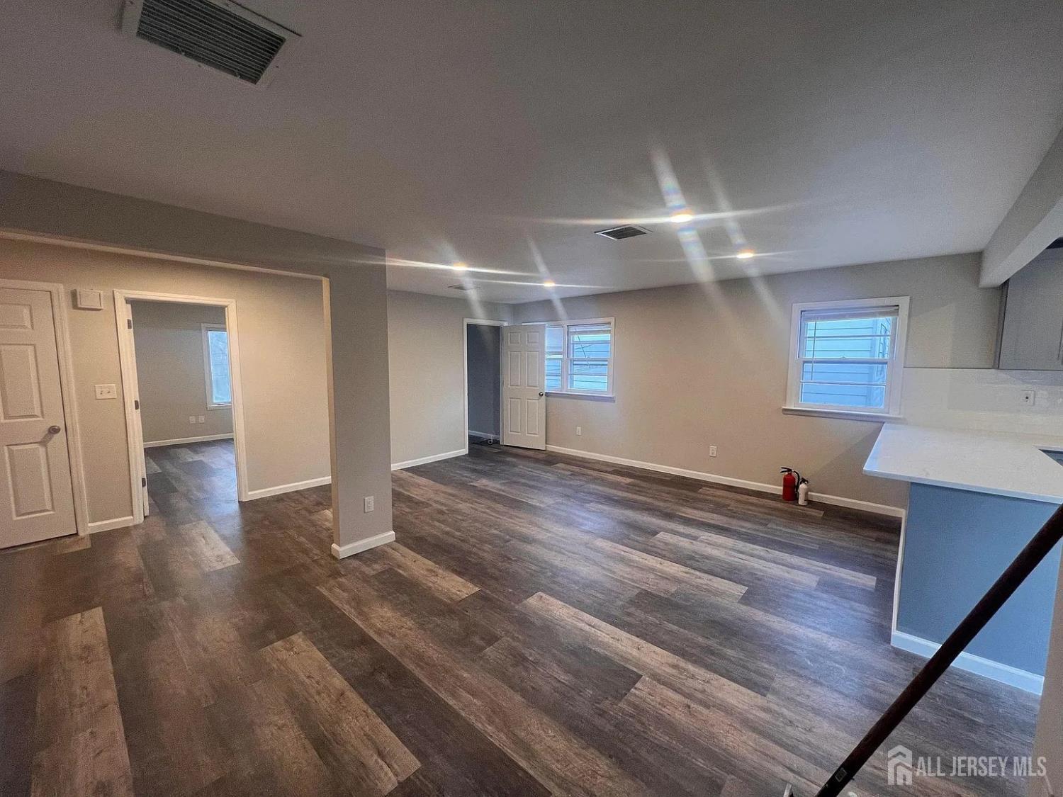249 Olsen Street, Unit 2 Sayreville, NJ 08879 - Photo 7 of 24 a room with wooden floor and window