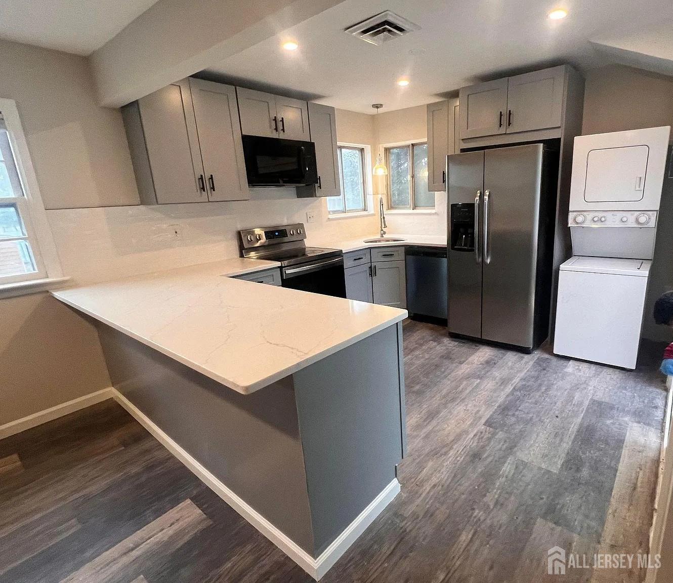 249 Olsen Street, Unit 2 Sayreville, NJ 08879 - Photo 9 of 24 a kitchen with stainless steel appliances a refrigerator sink and microwave