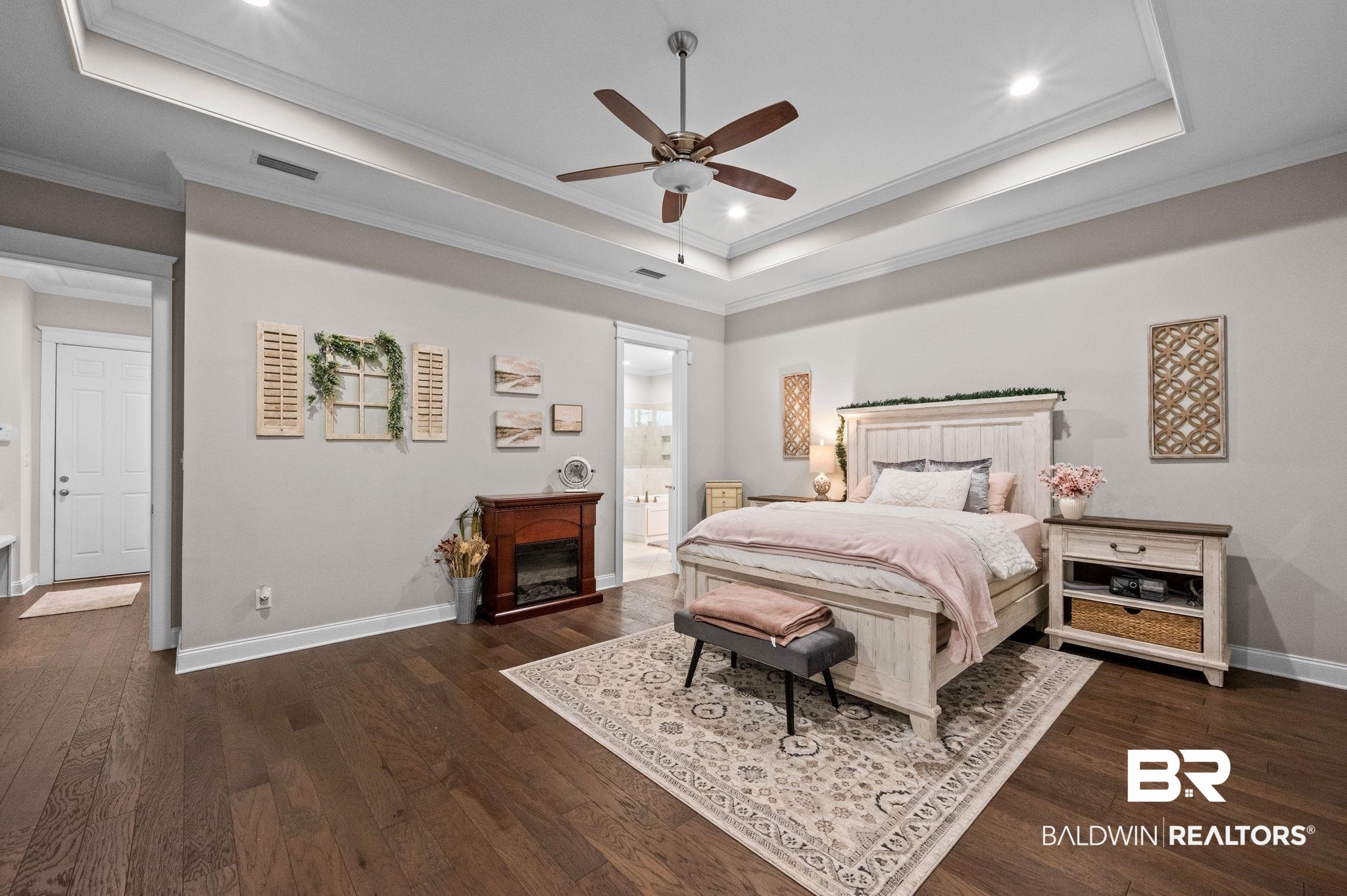 32194 Badger Court Daphne, AL 36527 - Photo 22 of 49 Bedroom with crown molding, ceiling fan, a raised ceiling, dark wood-type flooring, and ensuite bathroom