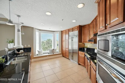 a kitchen with granite countertop a sink and a counter top space