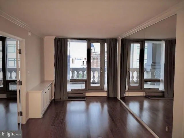 a view of an entryway with wooden floor and windows