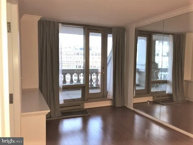 a view of an entryway with wooden floor