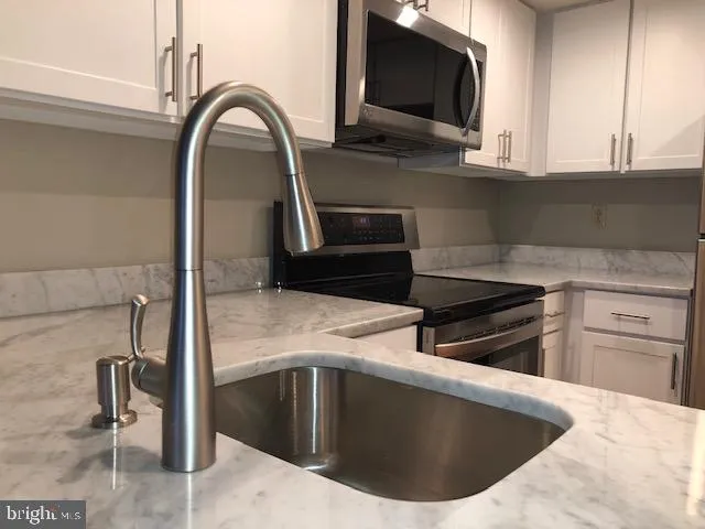 a kitchen with a sink and a microwave