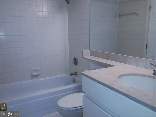 a bathroom with a granite countertop sink toilet and bathtub