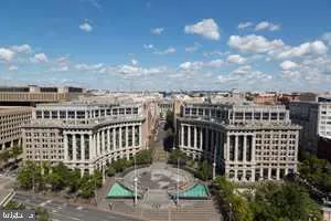a view of a roof deck with chair and wooden fence