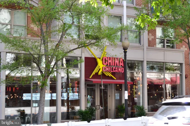a view of large building with a tree in front of it