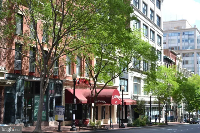 a front view of a multi story building with a tree