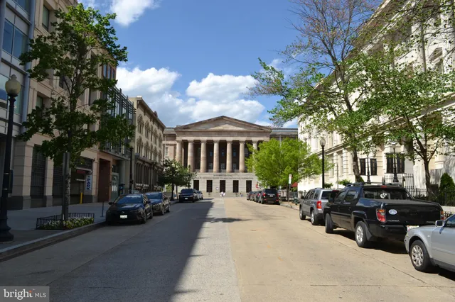 a view of a city street with a parked cars