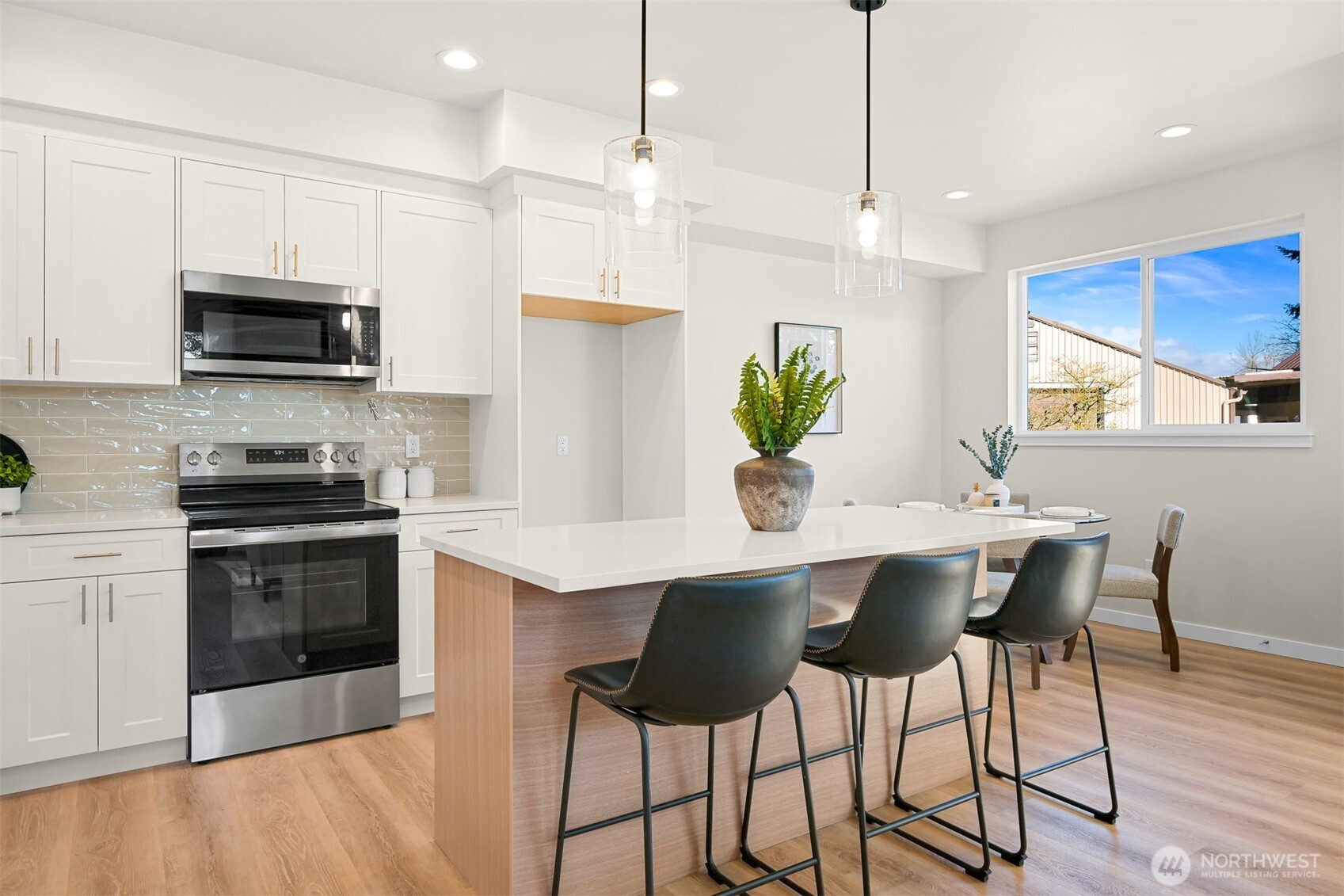 710 A F & S Grade Road, Unit B Sedro-Woolley, WA 98284 - Photo 6 of 38 a kitchen with stainless steel appliances a stove a sink a microwave a dining table and chairs