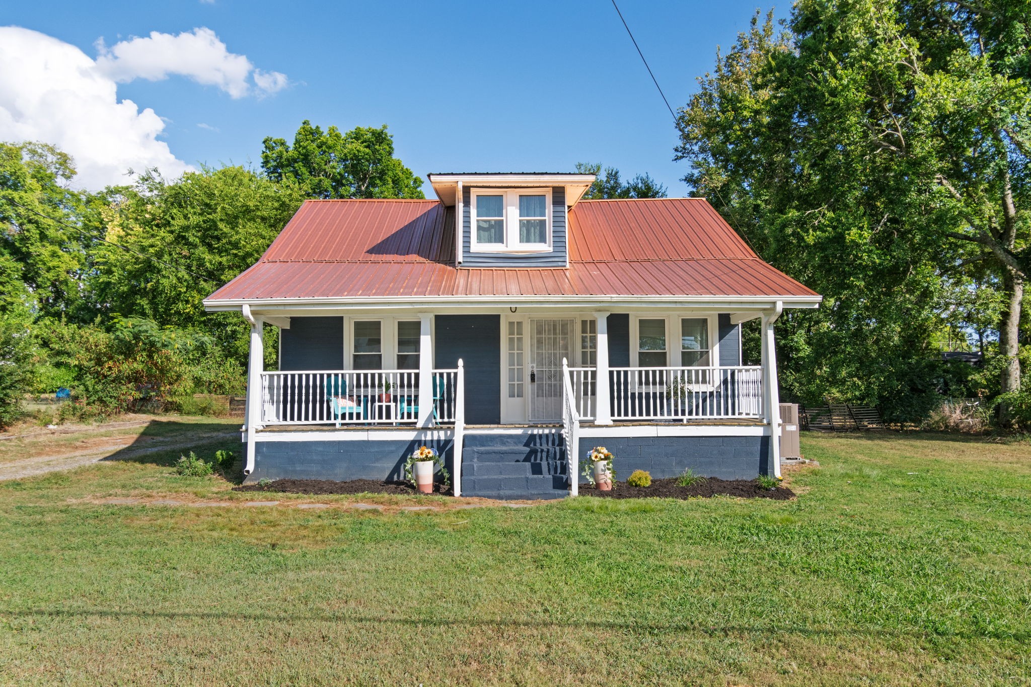 a front view of a house with a garden