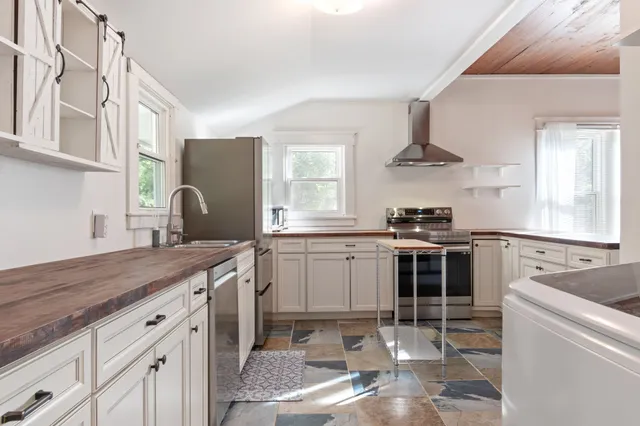 a kitchen with a sink stove and cabinets