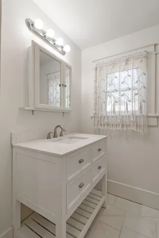 a bathroom with a sink and a mirror