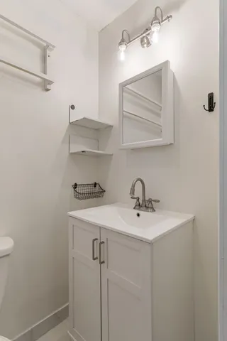 a bathroom with a sink vanity and a mirror