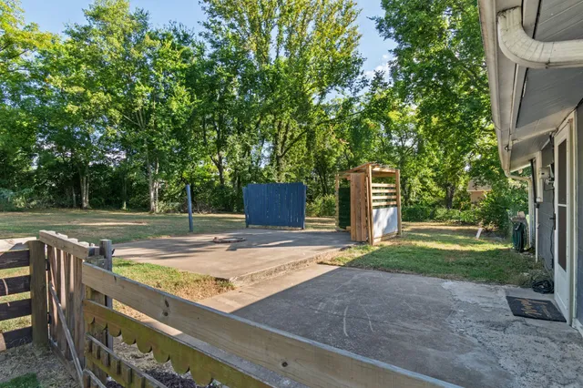 a view of a backyard with large trees