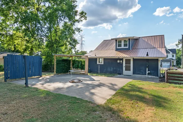a view of a house with a yard and sitting area
