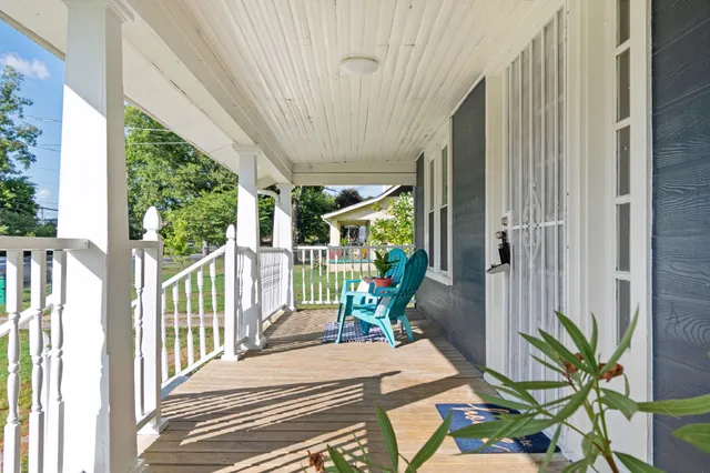 a view of a porch with furniture and garden