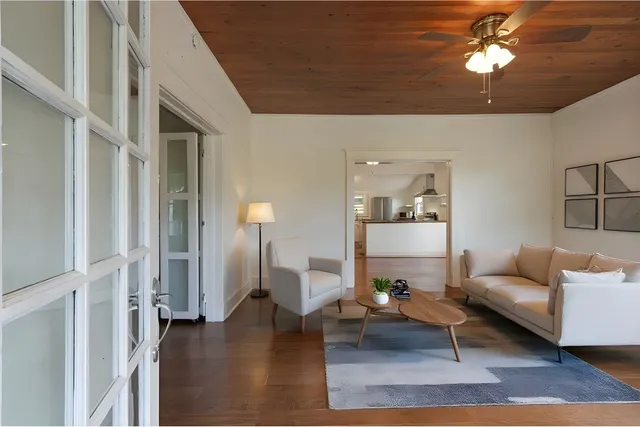 a living room with furniture and a chandelier