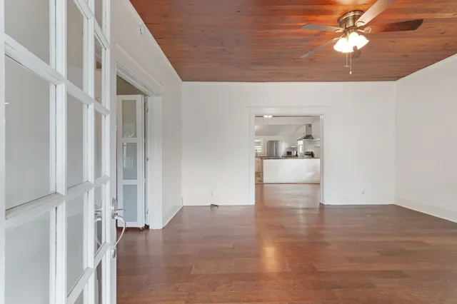a view of empty room with wooden floor