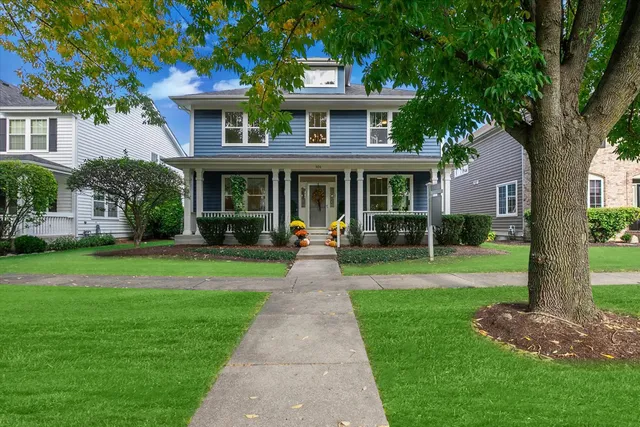 a front view of a house with yard and green space