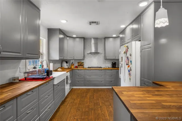 a kitchen with stainless steel appliances sink cabinets and window