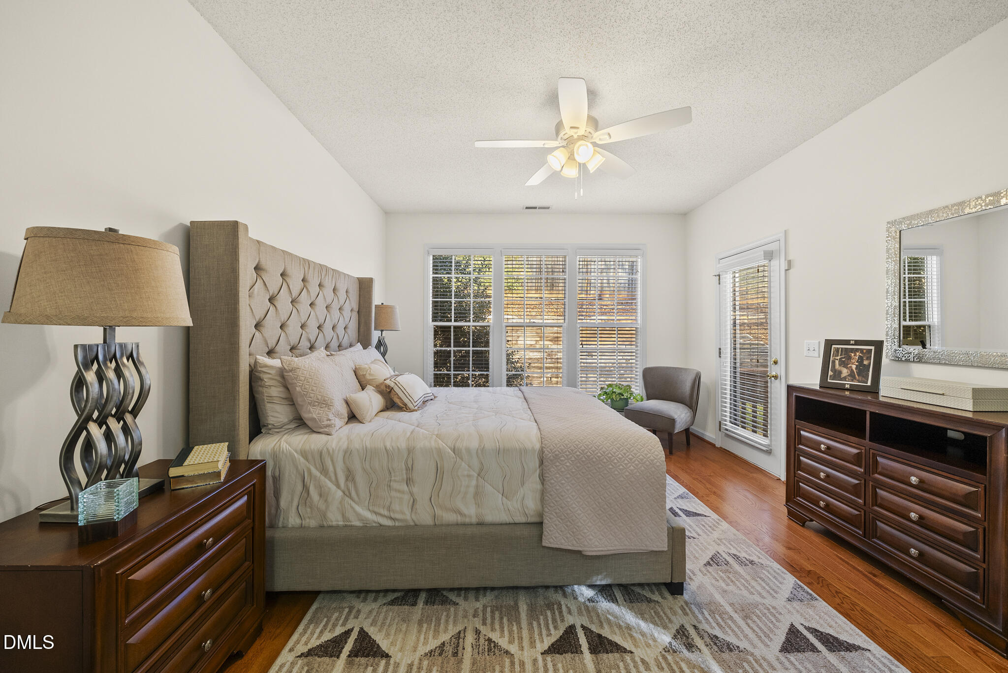 7710 Astoria Place Raleigh, NC 27612 - Photo 16 of 34 a bedroom with a bed and wooden floor