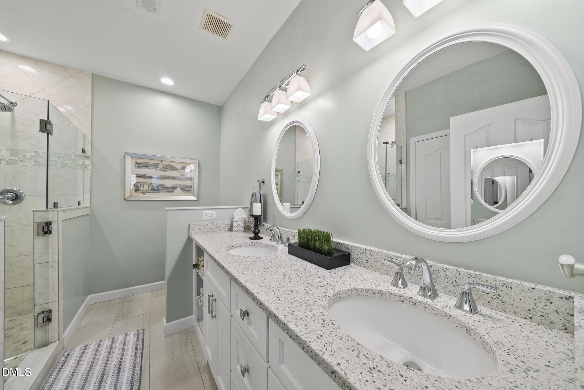 7710 Astoria Place Raleigh, NC 27612 - Photo 18 of 34 a bathroom with a granite countertop double vanity sink and a mirror