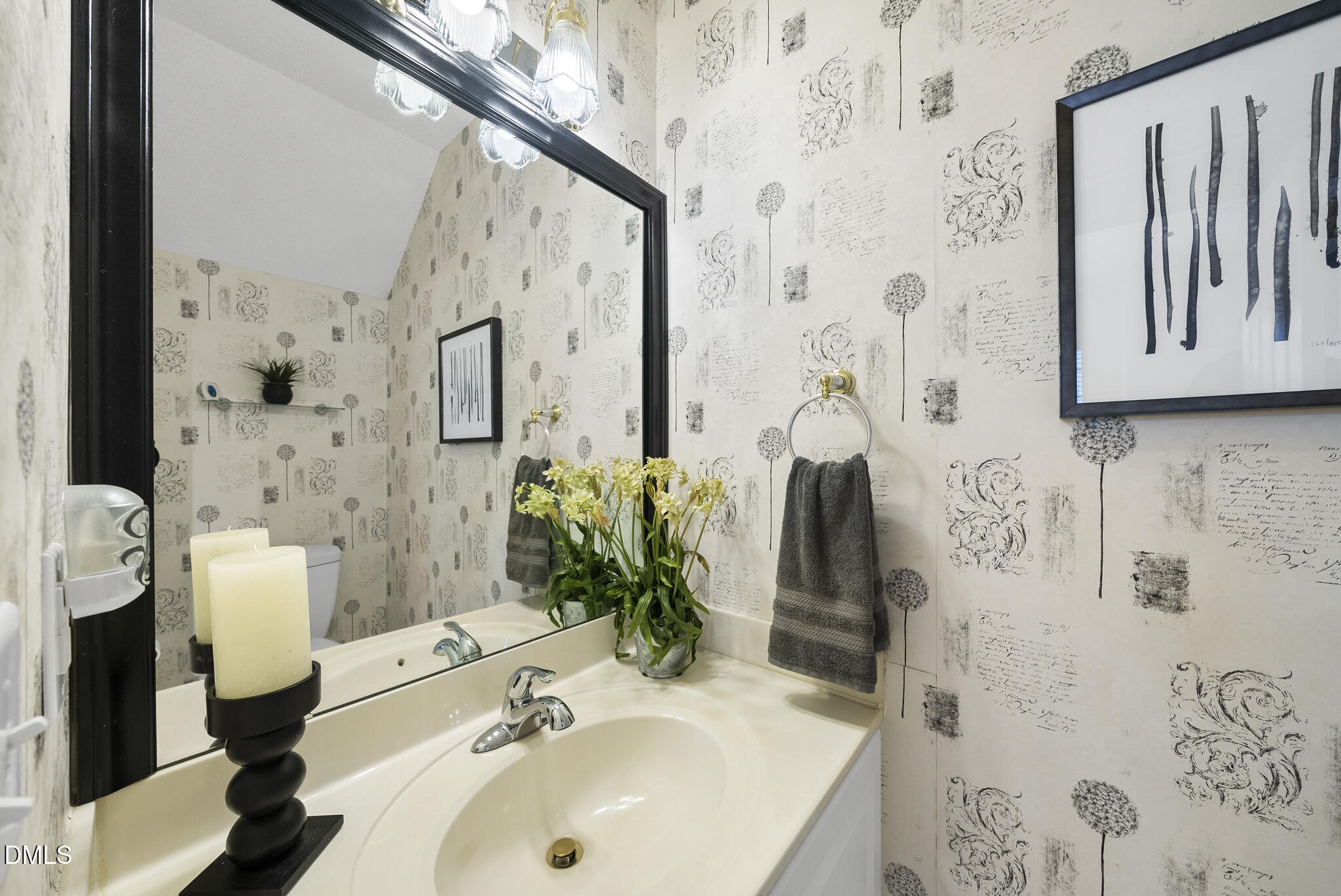 7710 Astoria Place Raleigh, NC 27612 - Photo 22 of 34 a bathroom with a sink and mirror with bathtub