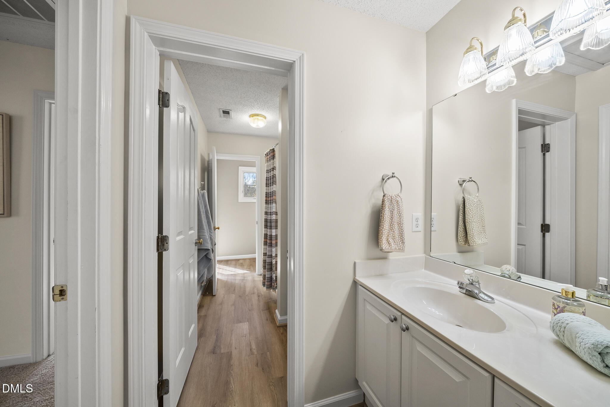 7710 Astoria Place Raleigh, NC 27612 - Photo 26 of 34 a bathroom with a double vanity sink and a mirror