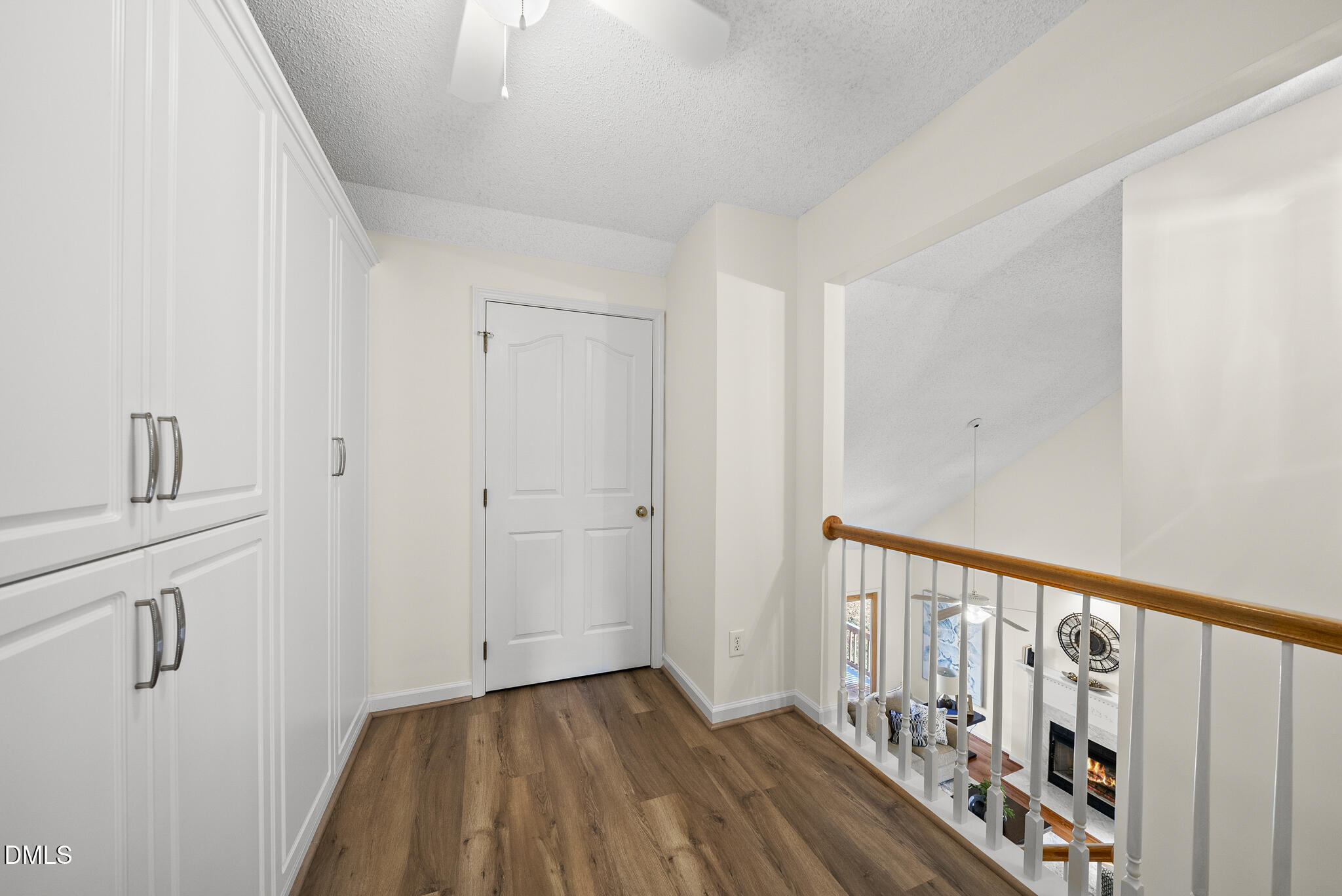 7710 Astoria Place Raleigh, NC 27612 - Photo 29 of 34 a view of a hallway with wooden floor and staircase