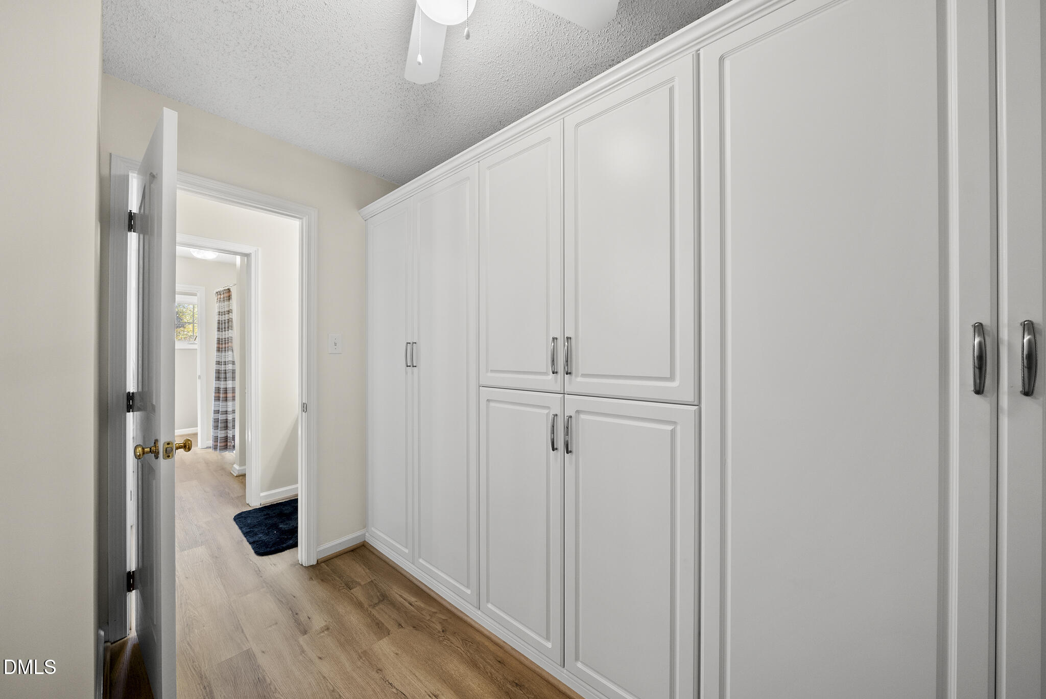 7710 Astoria Place Raleigh, NC 27612 - Photo 30 of 34 a view of a hallway with wooden floor and closet area