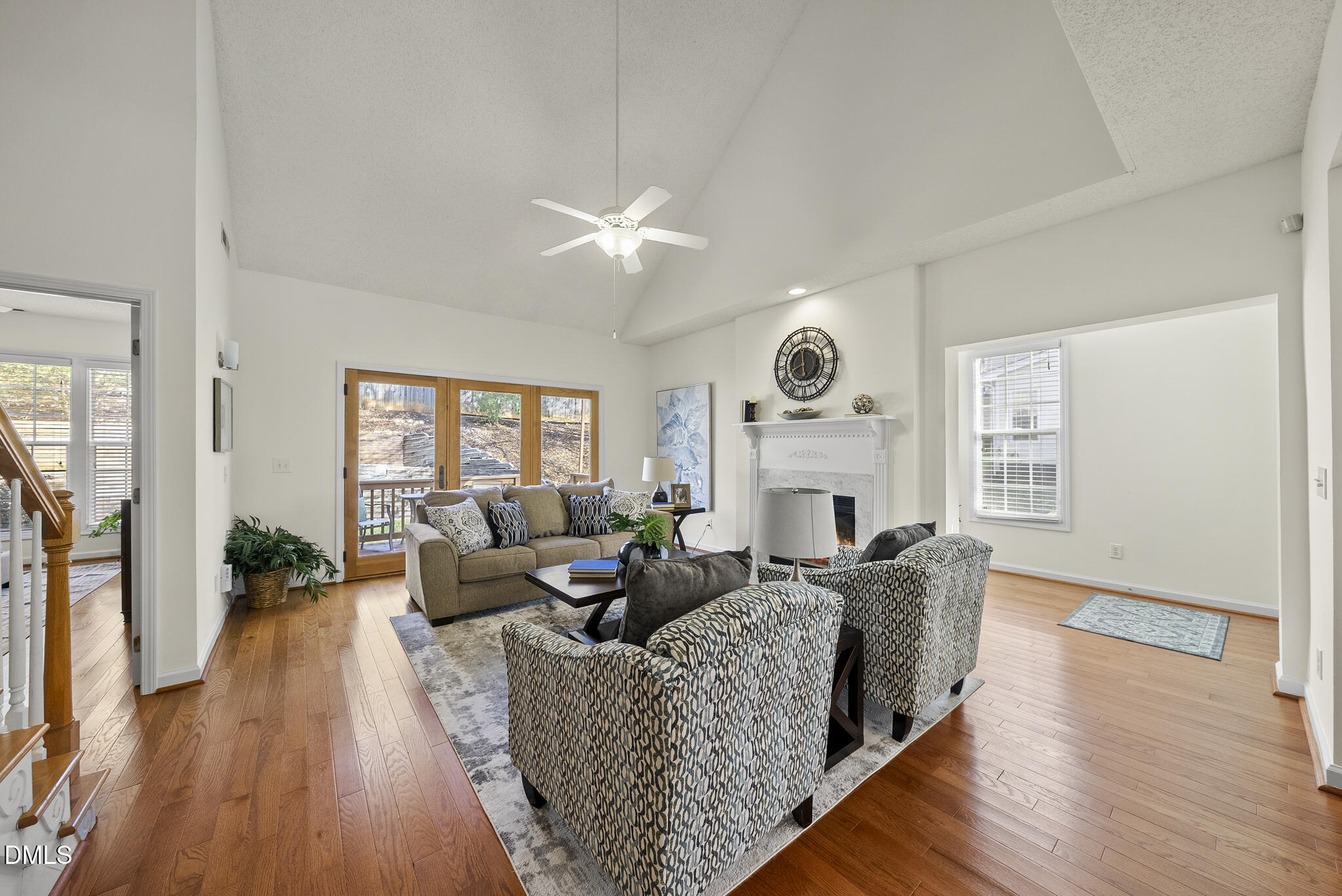7710 Astoria Place Raleigh, NC 27612 - Photo 4 of 34 a living room with fireplace furniture and a large window