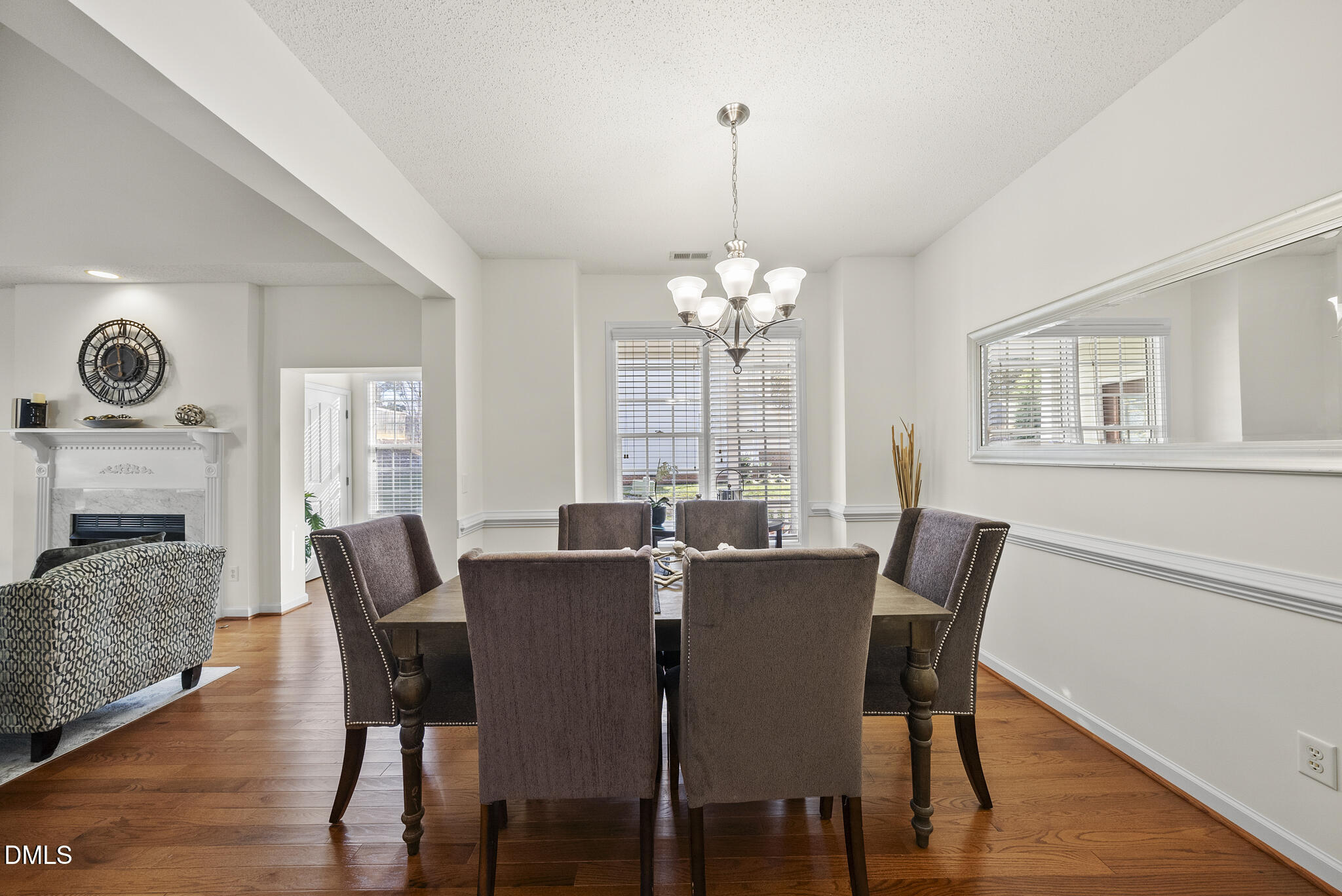 7710 Astoria Place Raleigh, NC 27612 - Photo 8 of 34 a view of a dining room with furniture window and wooden floor