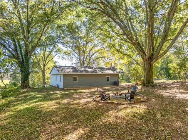 a view of backyard with large trees