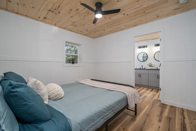 a bedroom with a bed and a chandelier