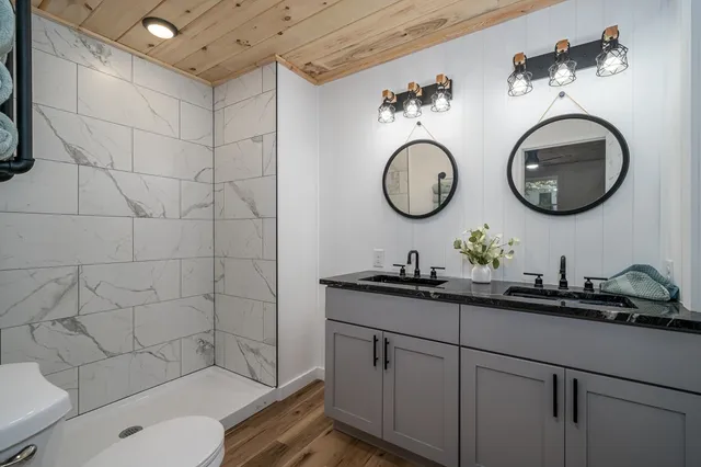 a bathroom with a toilet a sink and a mirror