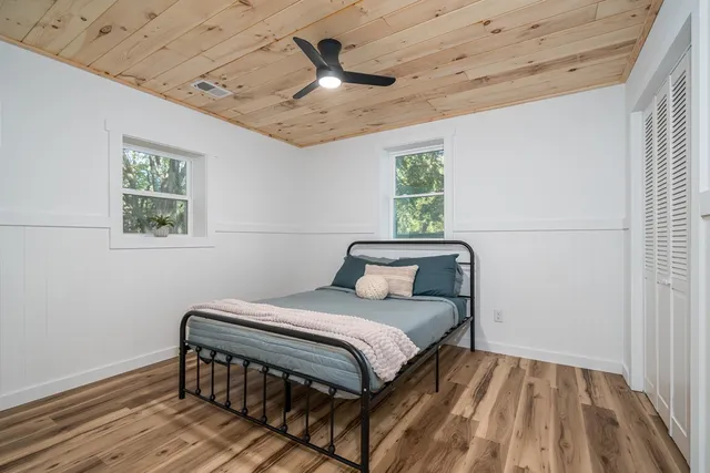 a bedroom with a bed and a window