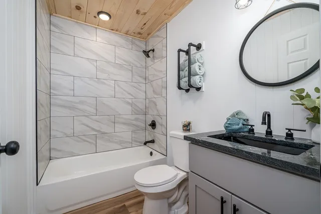 a bathroom with a sink a toilet and a mirror