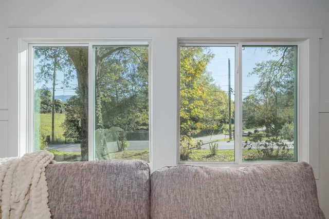 a living room filled with furniture and a large window