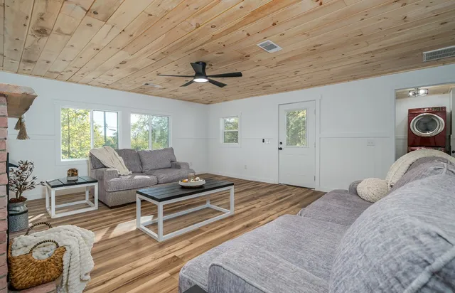 a bedroom with furniture and a large window