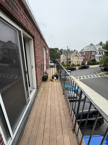 a view of balcony with wooden floor